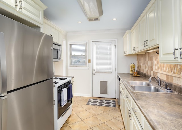 kitchen featuring sink, tasteful backsplash, appliances with stainless steel finishes, light tile patterned floors, and ornamental molding