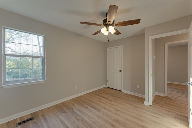 unfurnished bedroom with ceiling fan and light hardwood / wood-style floors