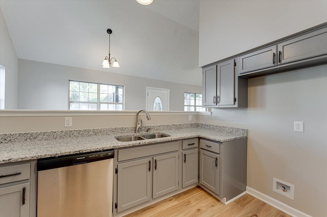 kitchen featuring a notable chandelier, sink, stainless steel dishwasher, light stone countertops, and decorative light fixtures