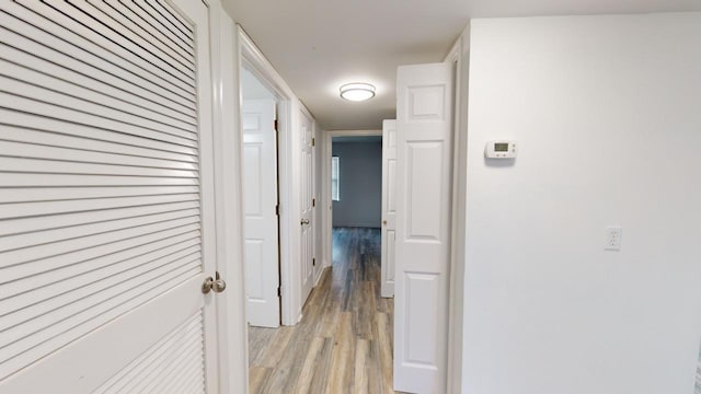 corridor with light hardwood / wood-style flooring