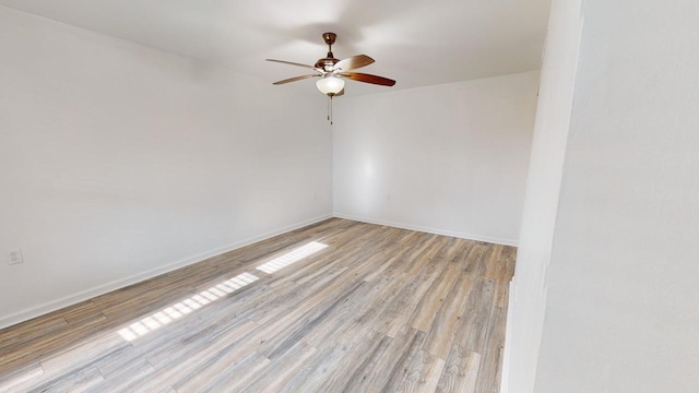 unfurnished room featuring ceiling fan and light wood-type flooring