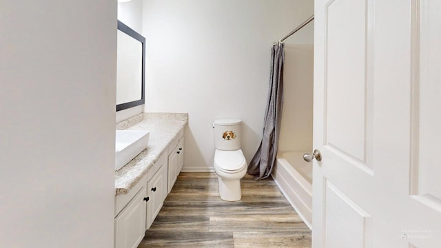 full bathroom featuring shower / bath combination with curtain, vanity, and toilet