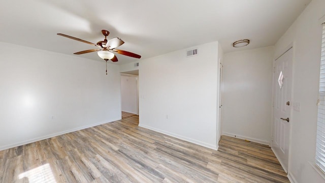 empty room featuring light wood-type flooring and ceiling fan