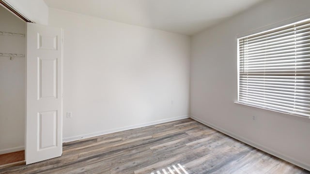 unfurnished room with wood-type flooring