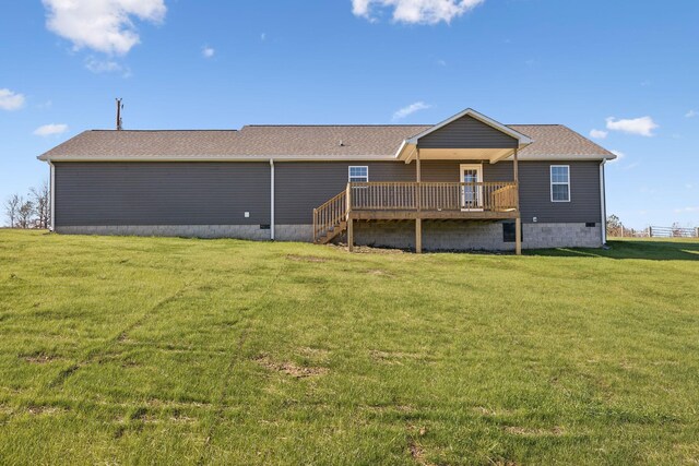 back of property featuring a deck and a yard