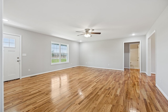 spare room featuring ceiling fan and light hardwood / wood-style flooring