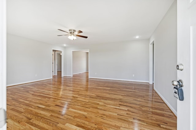 empty room featuring ceiling fan and light wood-type flooring