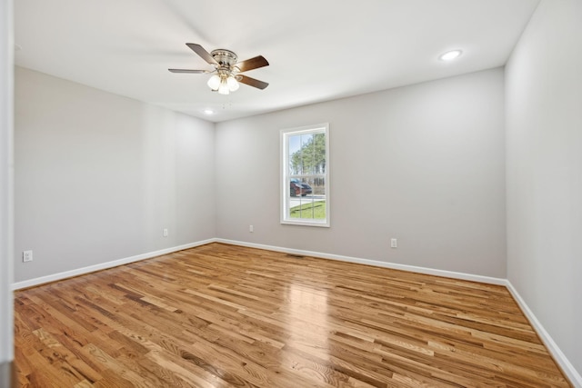 empty room featuring ceiling fan and light hardwood / wood-style flooring