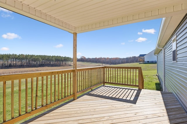 deck featuring a yard and a rural view