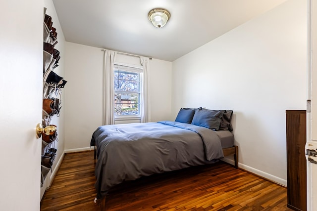 bedroom with dark hardwood / wood-style flooring