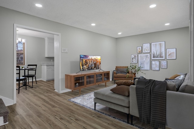 living room featuring light hardwood / wood-style floors and a textured ceiling