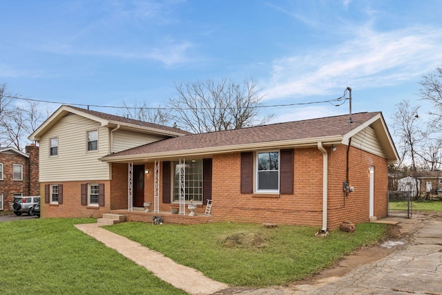 split level home featuring a front lawn and covered porch