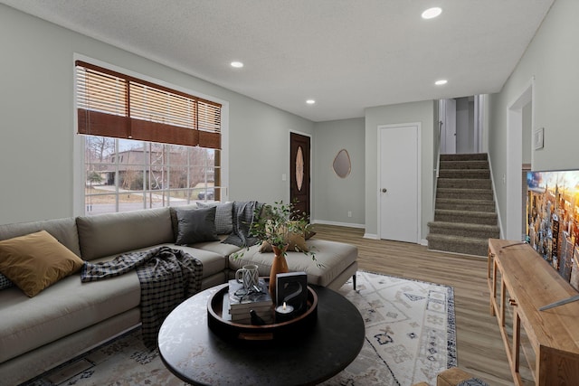 living room with light hardwood / wood-style floors and a textured ceiling