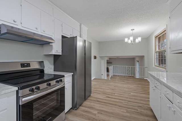 kitchen featuring a textured ceiling, appliances with stainless steel finishes, pendant lighting, light hardwood / wood-style floors, and white cabinets