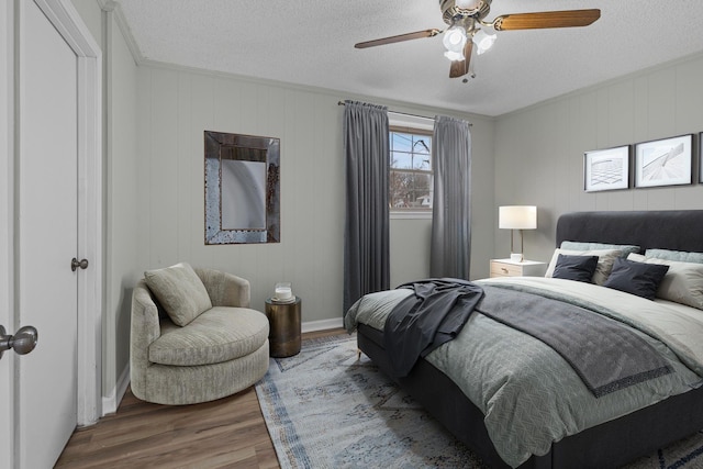 bedroom with wood-type flooring, a textured ceiling, and ceiling fan