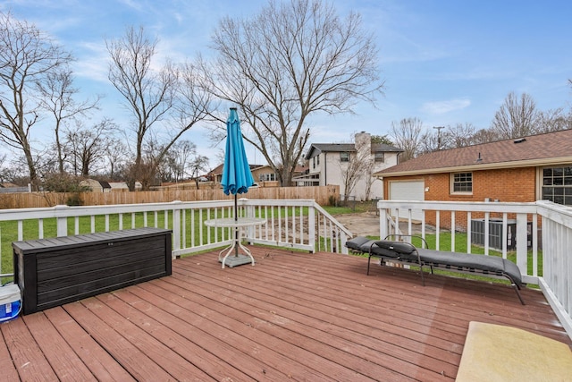 wooden deck featuring a lawn