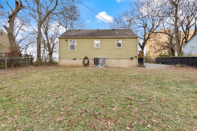 rear view of property with a lawn and central AC unit