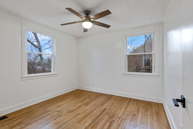 empty room featuring ceiling fan, ornamental molding, and light hardwood / wood-style flooring