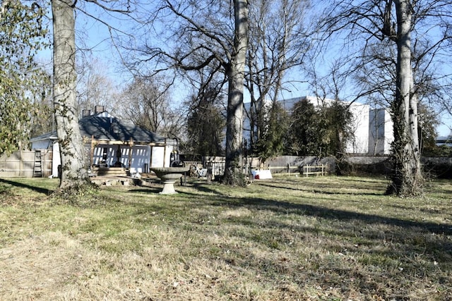 view of yard featuring a deck and fence