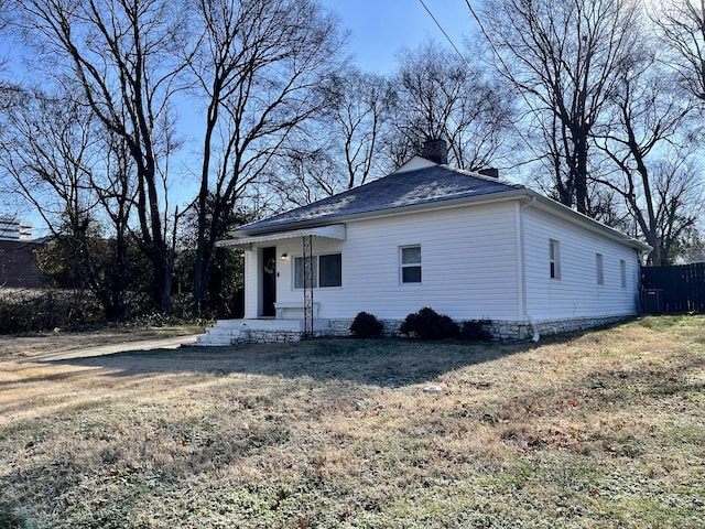 view of front of home featuring a shingled roof, a chimney, fence, and central air condition unit