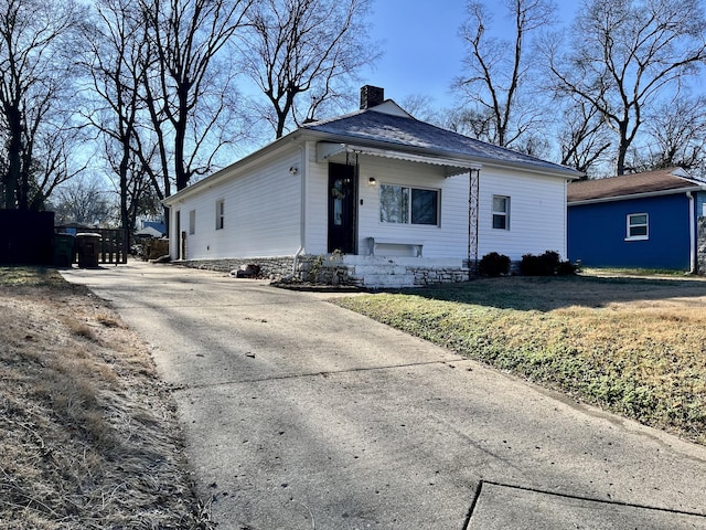 view of front of home featuring a front yard and a chimney