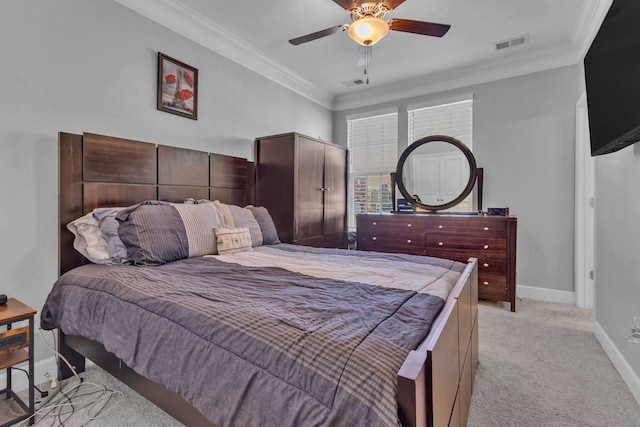 carpeted bedroom with ceiling fan and ornamental molding