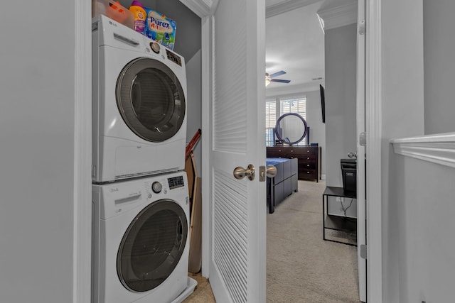 washroom with crown molding, ceiling fan, and stacked washer / drying machine