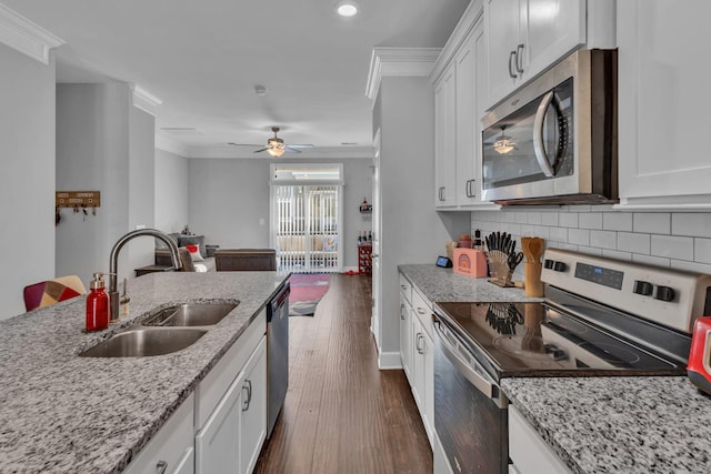 kitchen with white cabinets, sink, stainless steel appliances, and tasteful backsplash