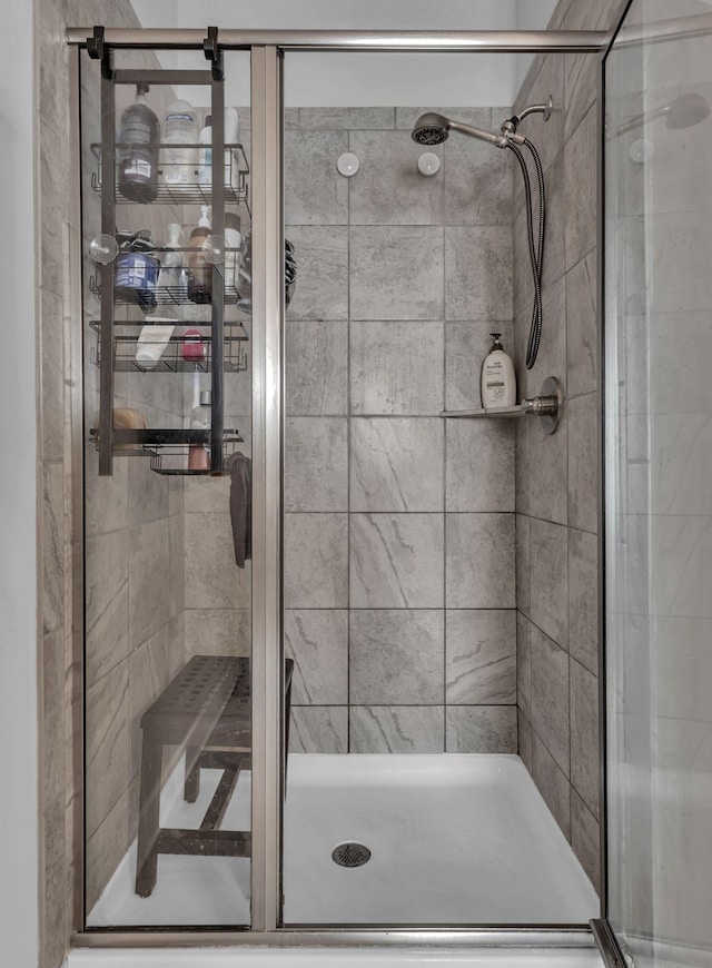 bathroom featuring a shower with door