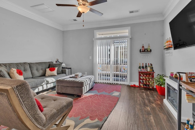 living room featuring ceiling fan, dark hardwood / wood-style flooring, and ornamental molding