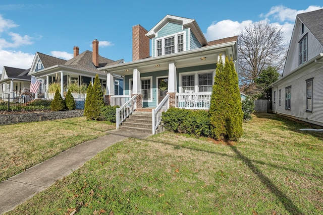 view of front of property with a porch and a front lawn