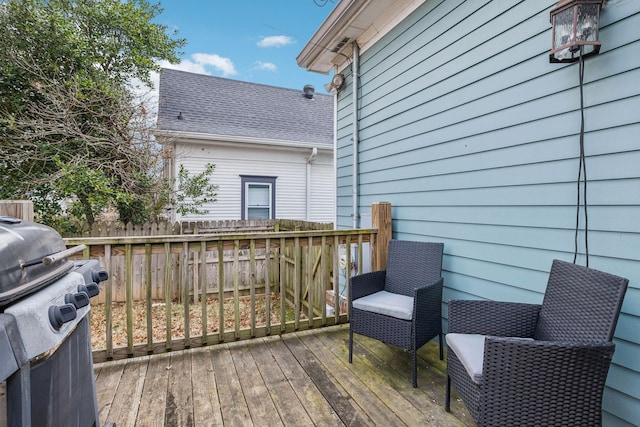 wooden deck with a grill