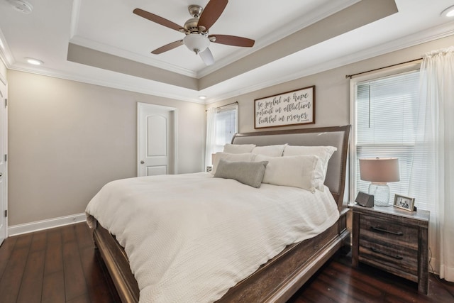 bedroom featuring ornamental molding, a raised ceiling, ceiling fan, and dark wood-type flooring