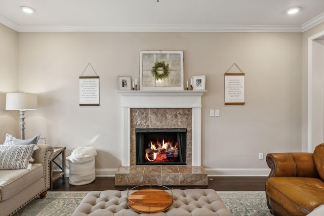 living room with a premium fireplace, dark hardwood / wood-style flooring, and crown molding