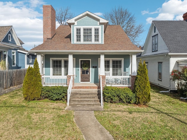 view of front of house with a front lawn and a porch