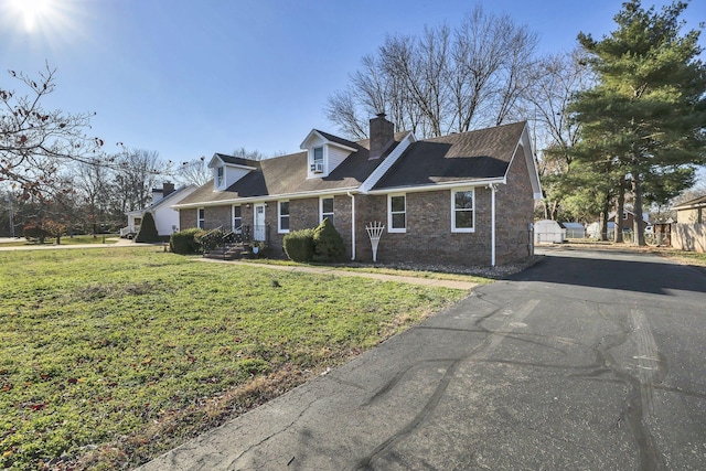 cape cod-style house with a front lawn