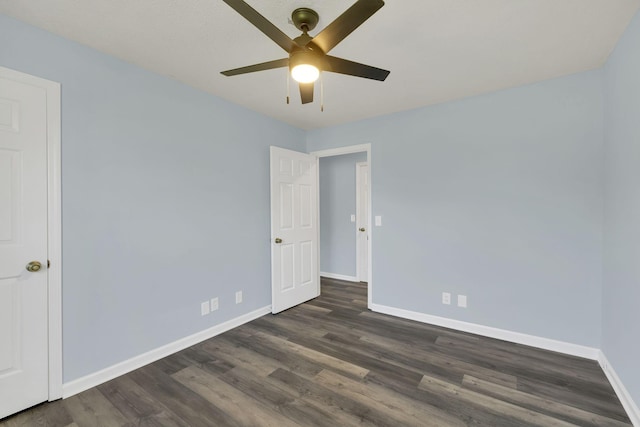 spare room featuring ceiling fan and dark wood-type flooring