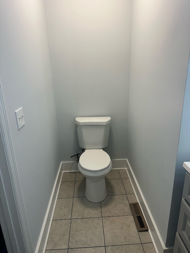 bathroom featuring tile patterned floors, vanity, and toilet