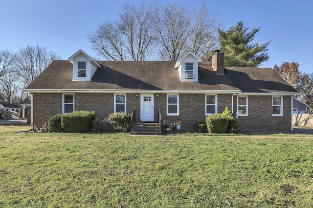 cape cod-style house featuring a front yard