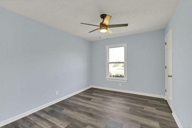 unfurnished room featuring ceiling fan, dark wood-type flooring, and a textured ceiling