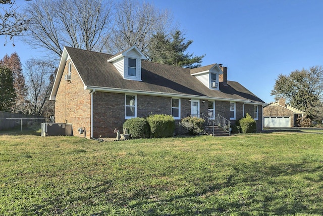 view of front of property featuring central air condition unit and a front yard