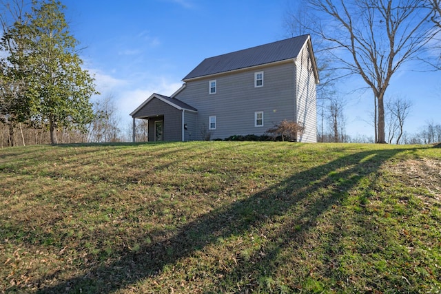 rear view of house featuring a yard