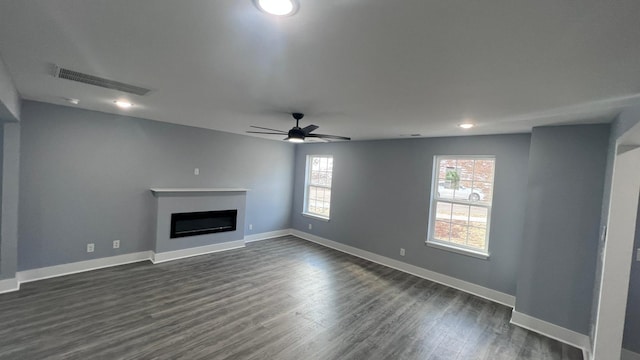 unfurnished living room featuring dark hardwood / wood-style floors and ceiling fan