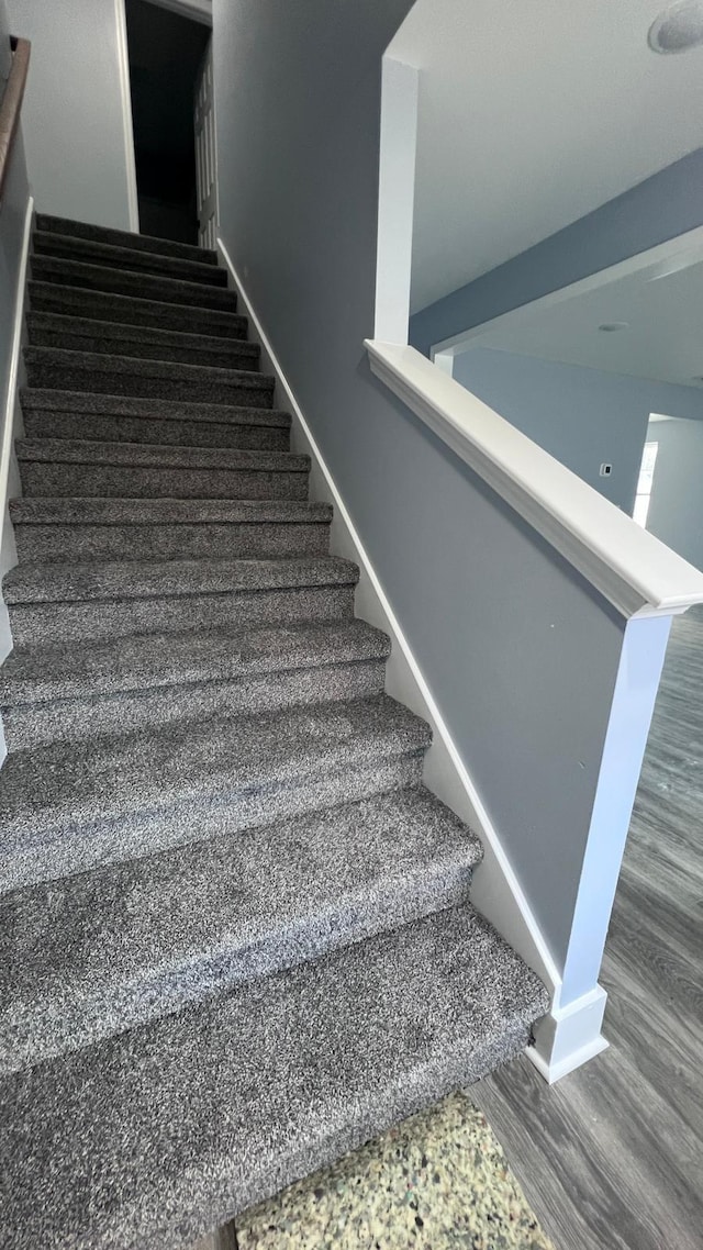 staircase with hardwood / wood-style flooring