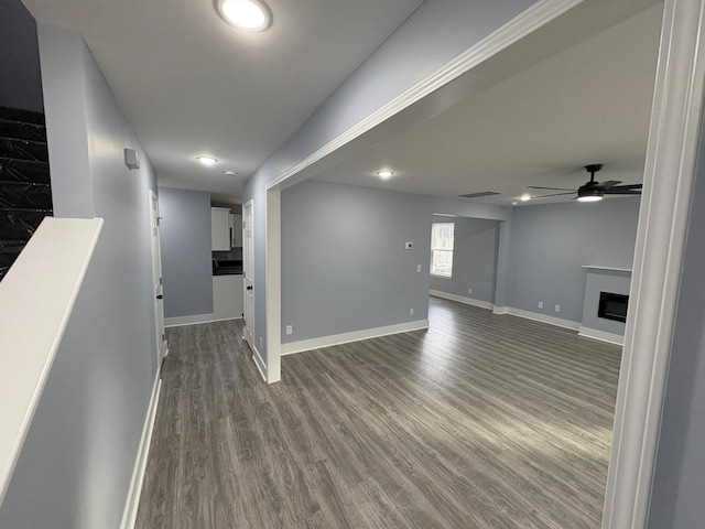 interior space featuring dark wood-type flooring and ceiling fan