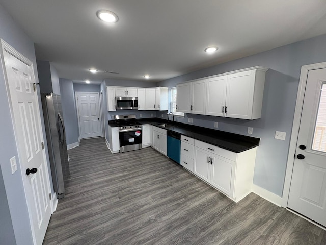 kitchen featuring white cabinetry, sink, stainless steel appliances, and dark hardwood / wood-style floors