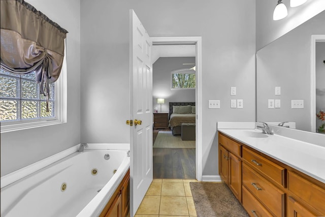 bathroom featuring tile patterned flooring, vanity, and a bath