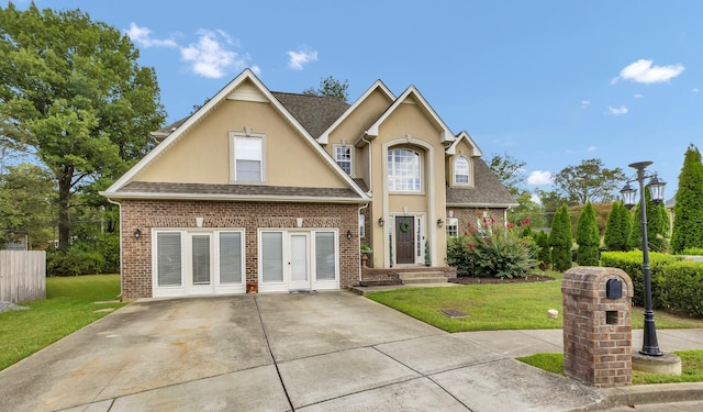 view of front facade featuring french doors and a front yard