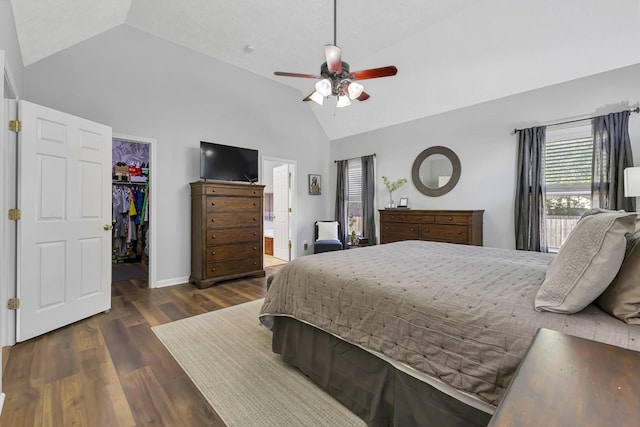 bedroom featuring a walk in closet, ensuite bathroom, vaulted ceiling, and ceiling fan