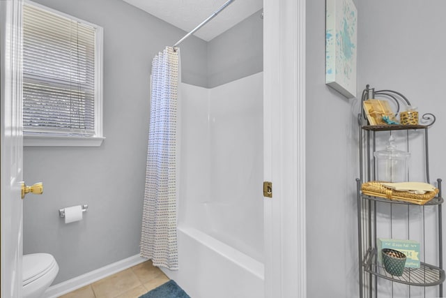 bathroom featuring toilet, shower / bath combo, and tile patterned floors